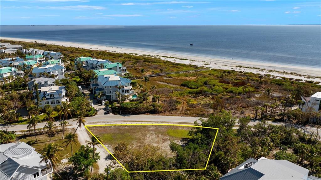 Aerial view of residential area featuring unending shoreline and property boundaries highlighted