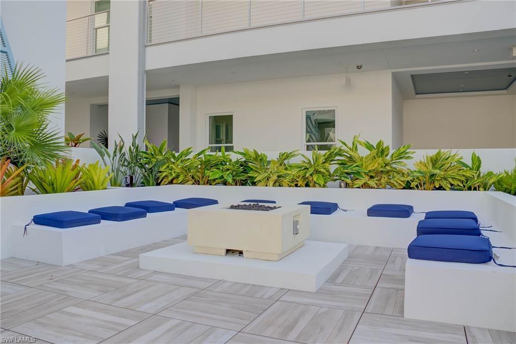 Community pool and hot tub are next to the fire pit area with grilling area on the other side