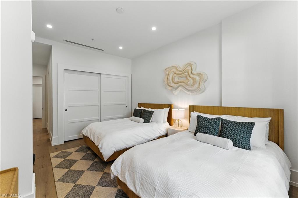 Bedroom featuring wood finished floors, recessed lighting, and a closet