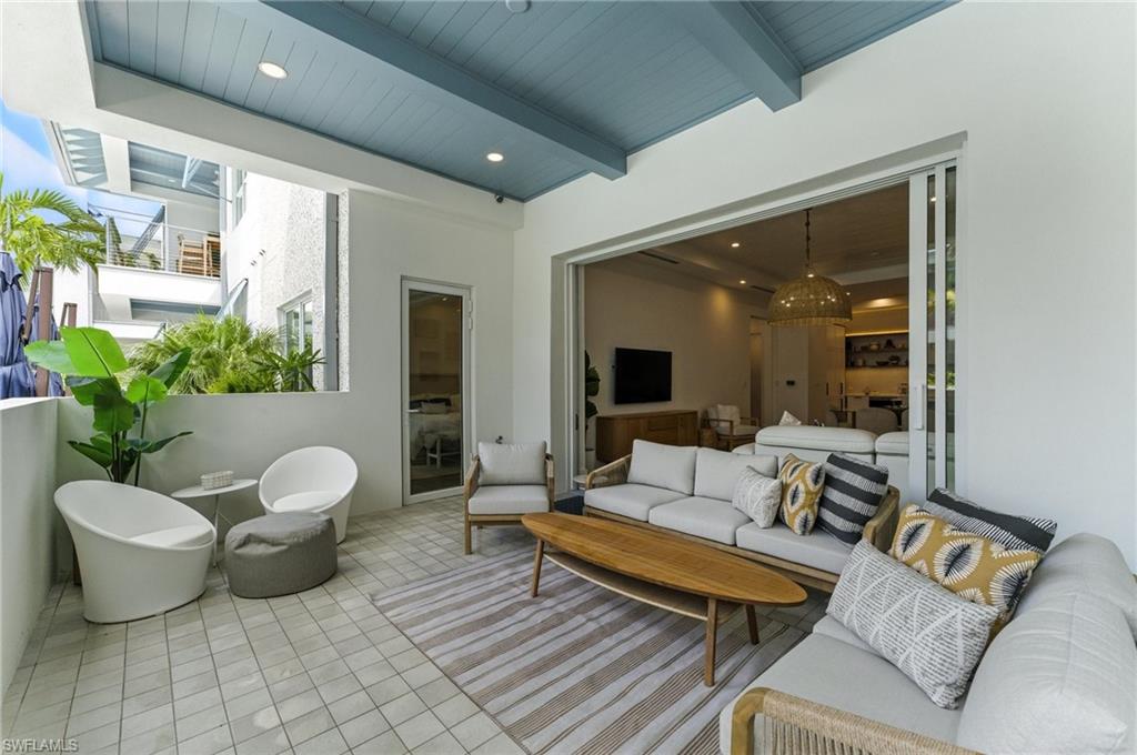 Tiled living area featuring a wooden ceiling with exposed beams and recessed lighting - IMPACT SLIDERS AND WINDOWS - DOOR TO PRIMARY OFF PATIO - SOUTHERN EXPOSURE