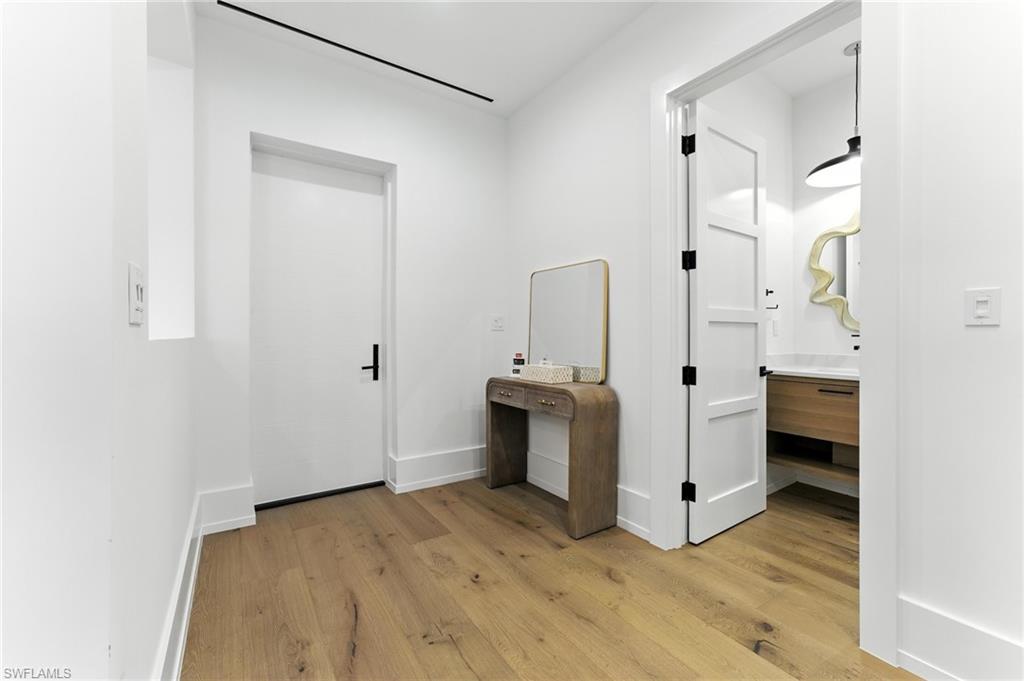 Corridor with light wood finished floors and baseboards