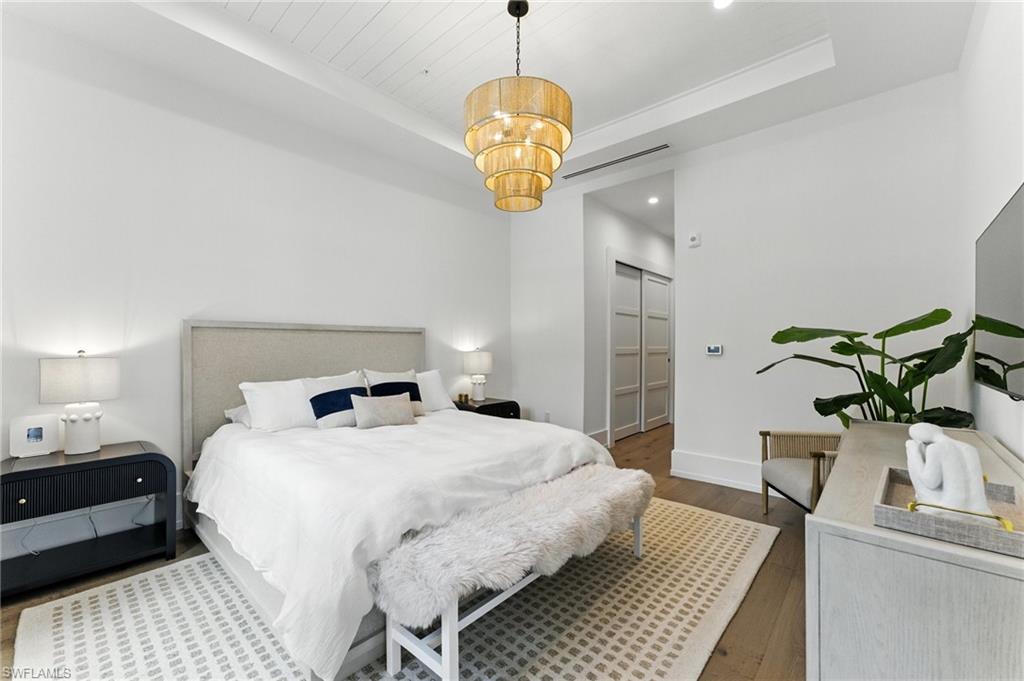 Bedroom features a king bed, walkout to patio area, two closets, and en-suite primary bathroom