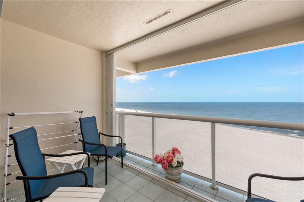 Private balcony featuring a glass railing system and tile flooring