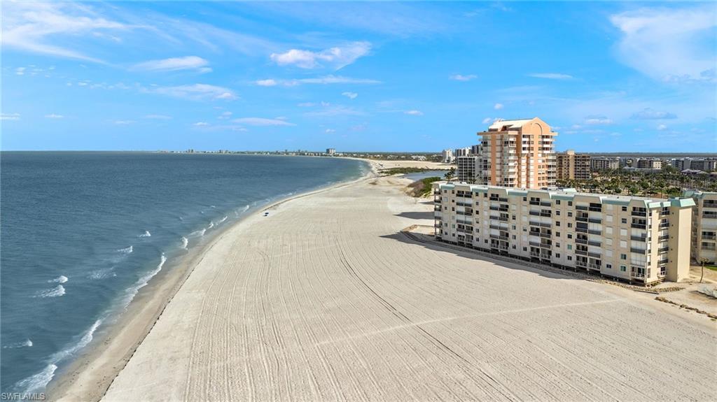 Expansive sandy beach with breaking waves
