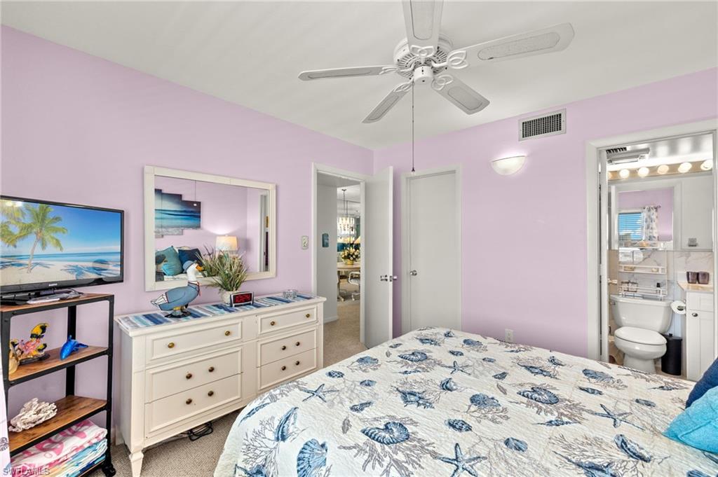 Carpeted bedroom featuring a ceiling fan with light fixture, recessed lighting, and a wall-mounted sconce