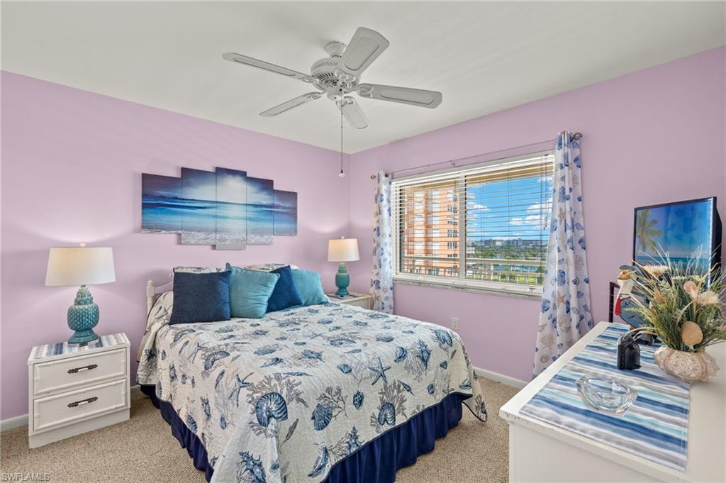Bedroom with large window, ceiling fan, and carpeted flooring