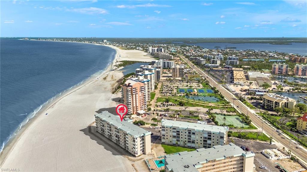 Beachfront condominium building on a sandy shore
