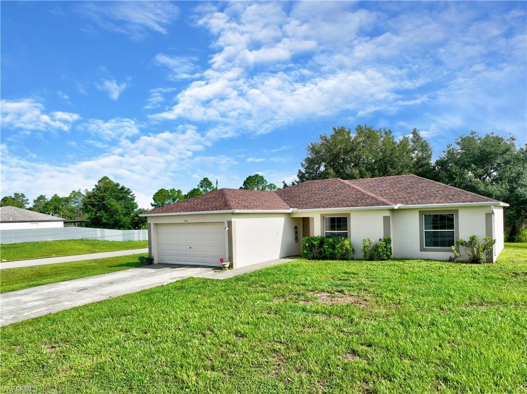 Single-story residence featuring a two-car garage, concrete driveway, and a shingle roof