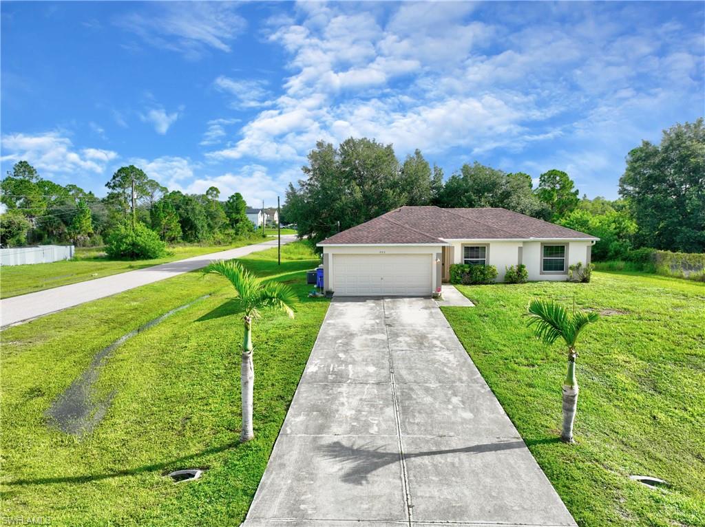 Single-story residence featuring a two-car garage and a concrete driveway