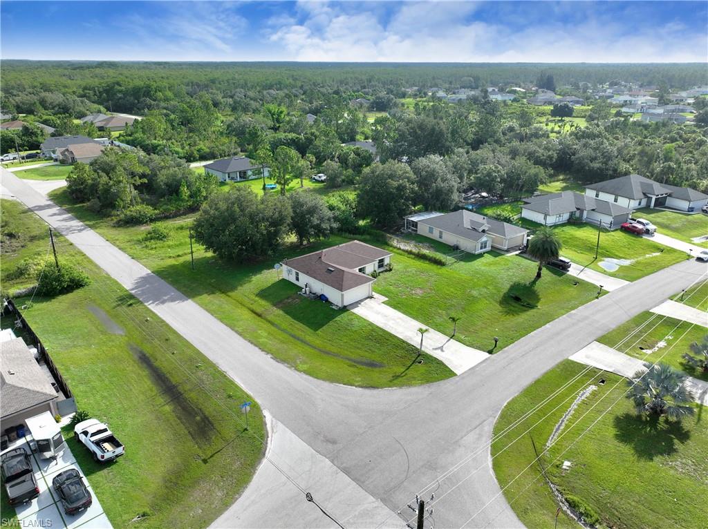 Aerial view of a residential neighborhood featuring single-story homes with light-colored roofs