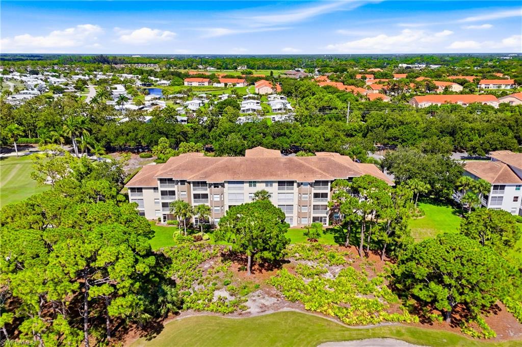 Breathtaking aerial view showcasing the beautifully designed Highland Woods Golf & Country Club, surrounded by lush tropical landscaping and pristine fairways.