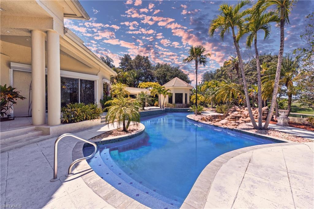 Pool at dusk featuring a patio
