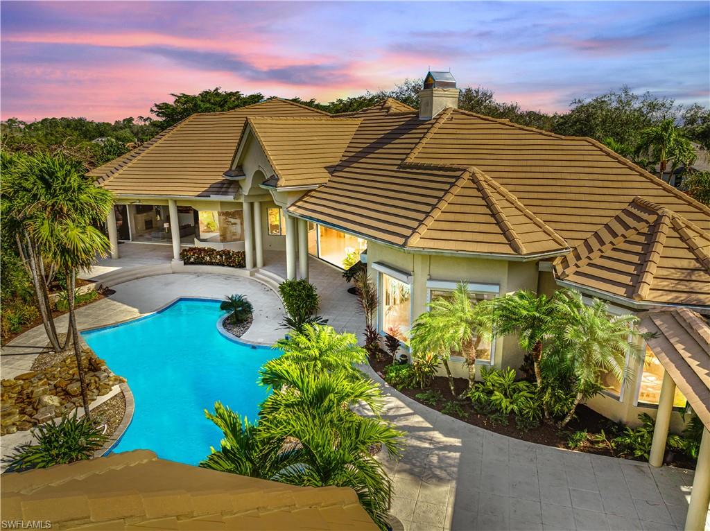 Pool at dusk with a patio area