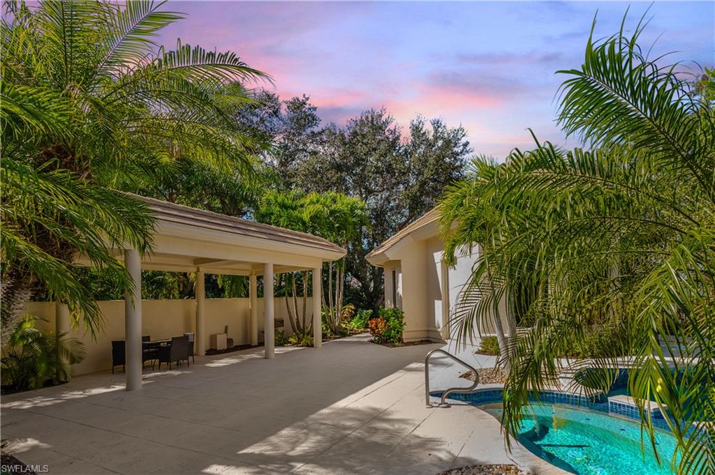 Pool at dusk with a gazebo and a patio