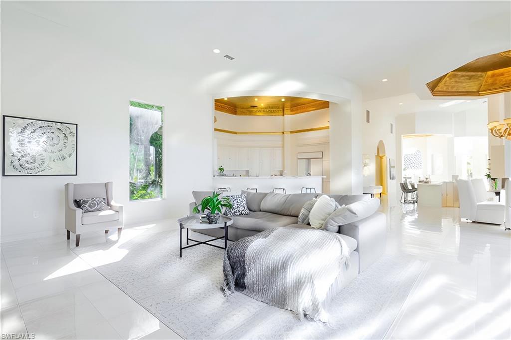 Tiled living room with a towering ceiling