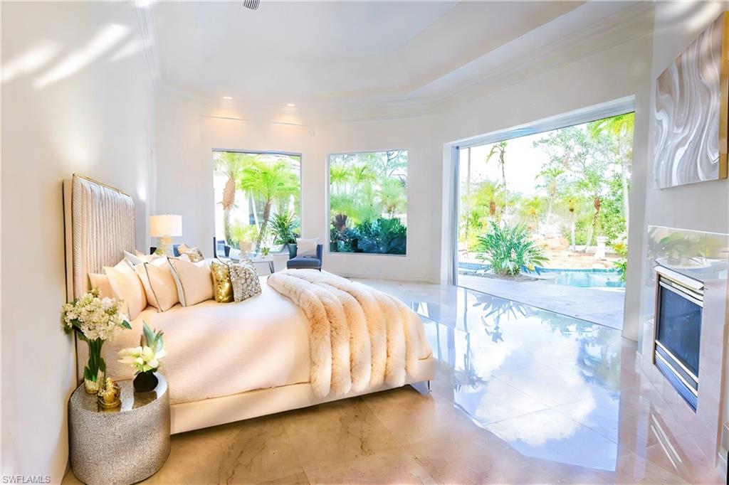 Bedroom with crown molding and access to outside
