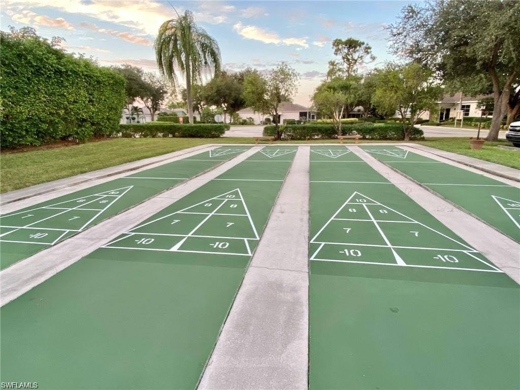 Multiple shuffleboard courts featuring green surfacing and white game markings
