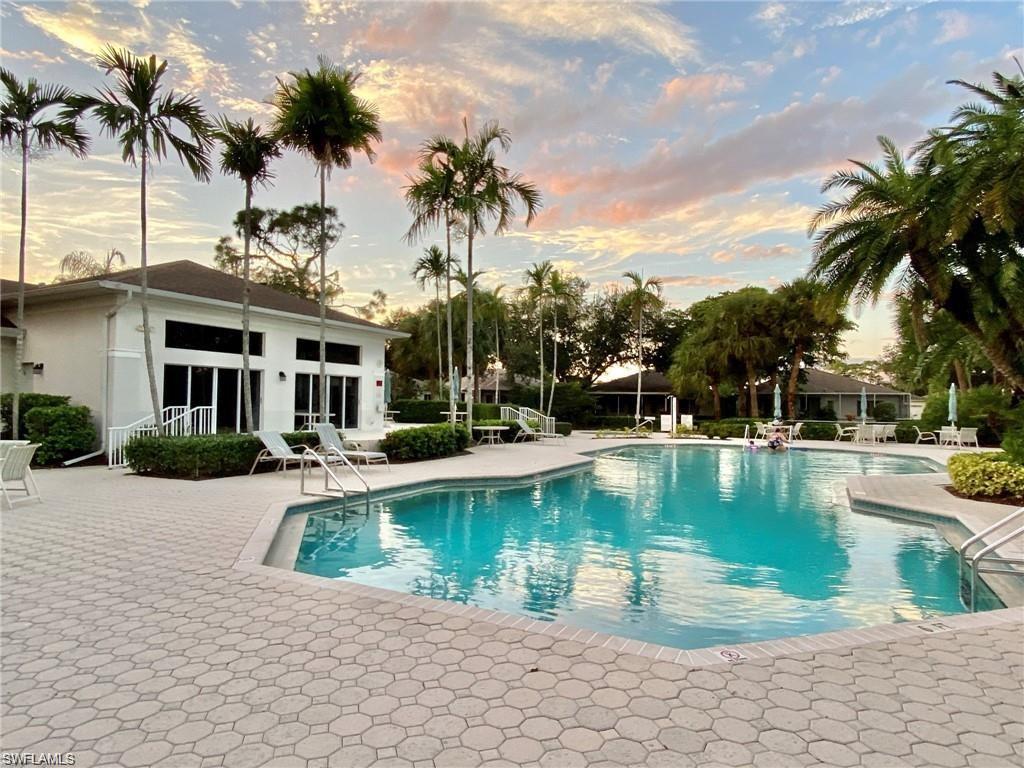 Expansive outdoor pool area featuring a large, irregularly shaped swimming pool with integrated steps