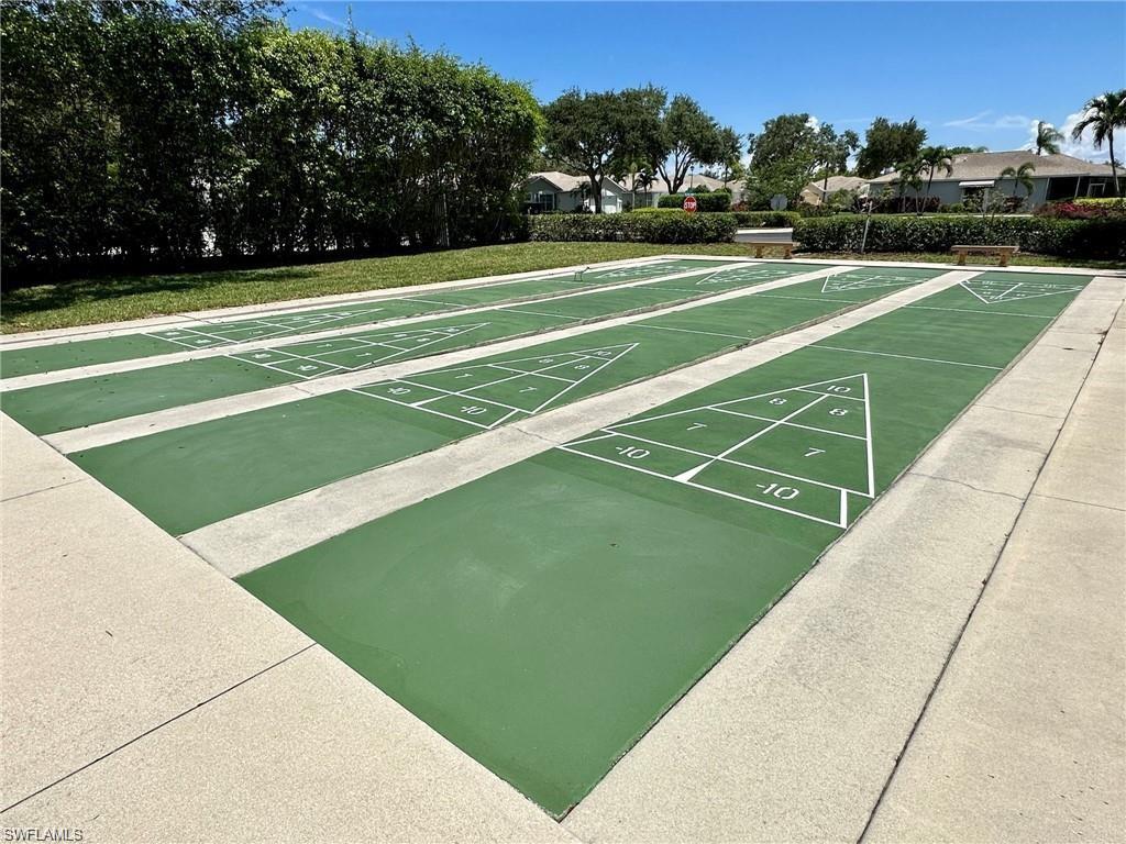 Multiple shuffleboard courts featuring green surfacing and white game markings