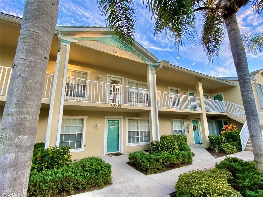 Multi-story building featuring a stucco exterior with teal accents