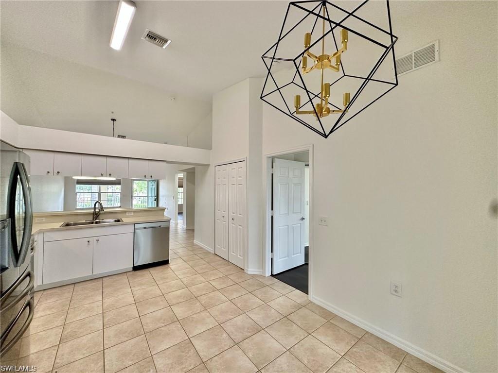 Kitchen space with vaulted ceiling and contemporary geometric chandelier