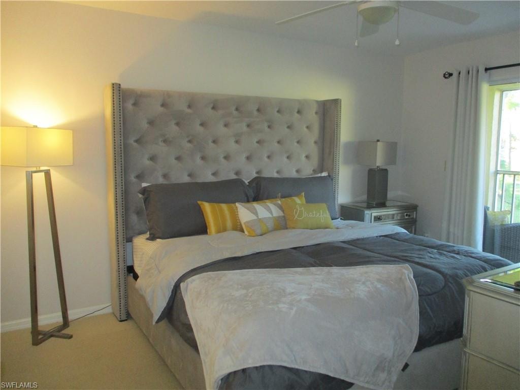 Bedroom with baseboards, carpet floors, and ceiling fan
