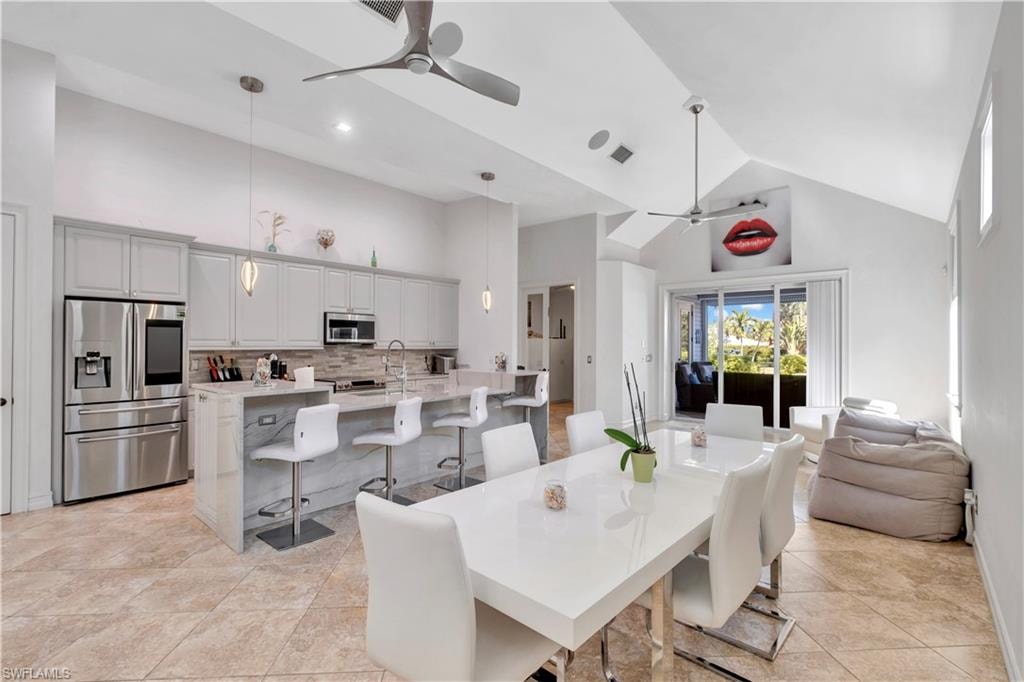 Open-concept living area with a full kitchen, dining space, and outdoor access