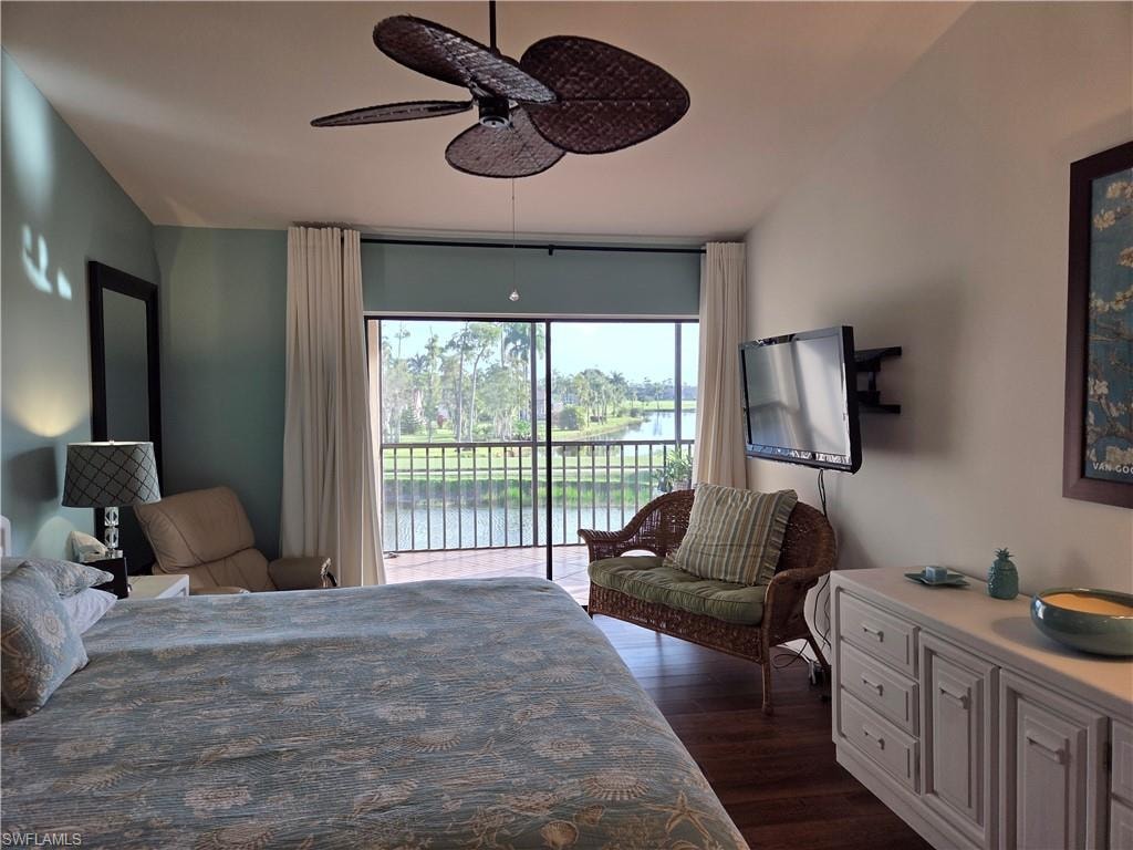 Room featuring a screened balcony overlooking a body of water and tropical landscaping