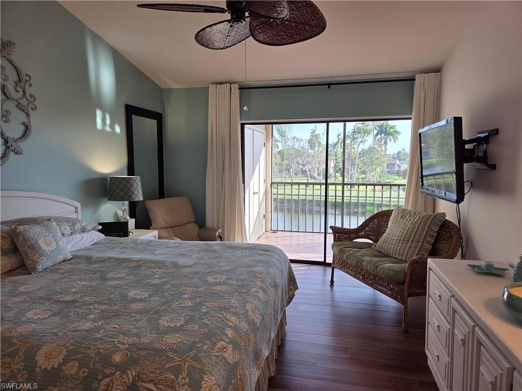 Bedroom featuring direct access to a screened balcony overlooking a tranquil water feature