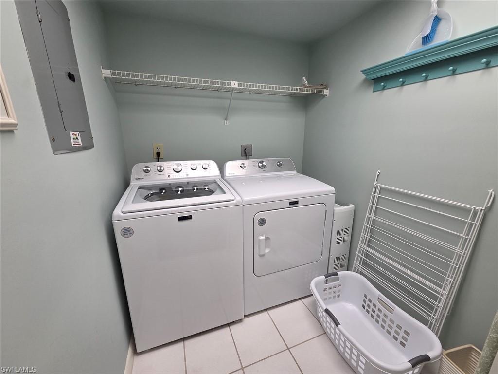 Dedicated laundry area featuring a white top-load washer and front-load dryer