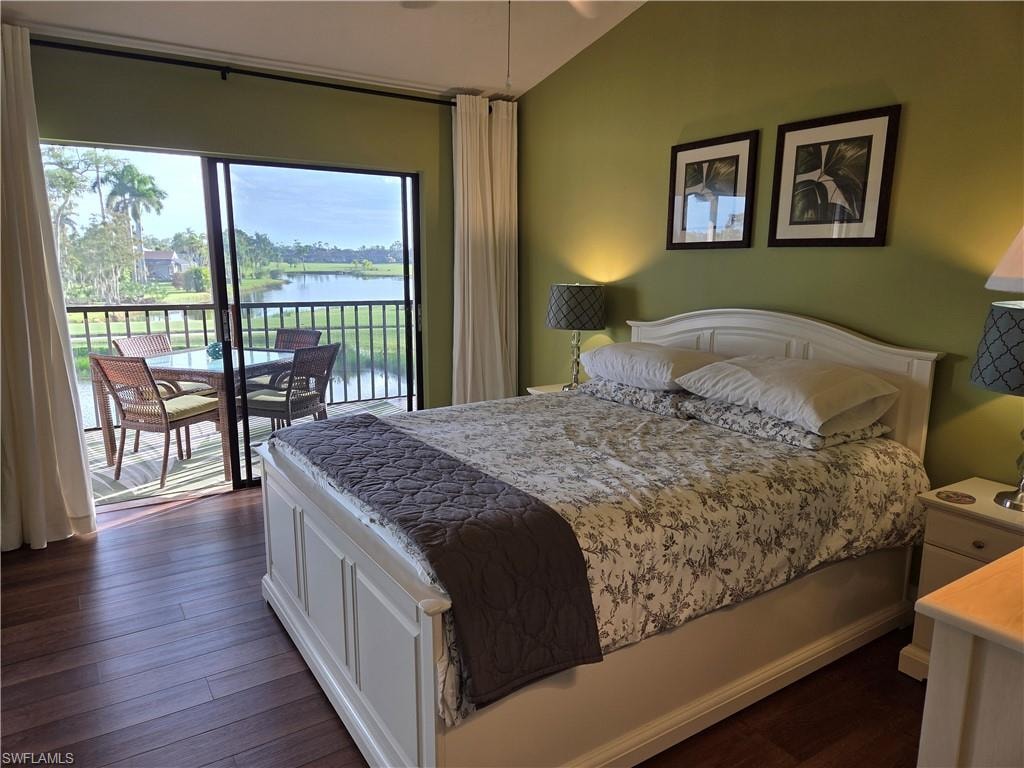 Spacious room featuring wood-finish flooring, light green walls, a white arched headboard, and direct access to a screened balcony