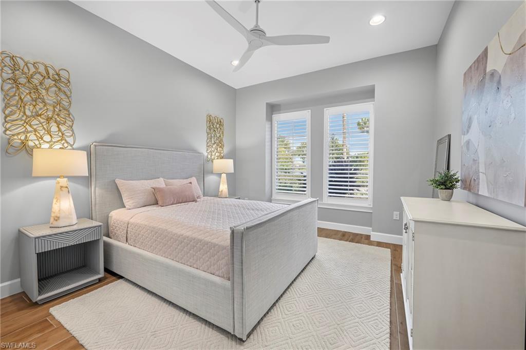 Spacious room featuring wood-finish flooring, recessed lighting, and a contemporary ceiling fan