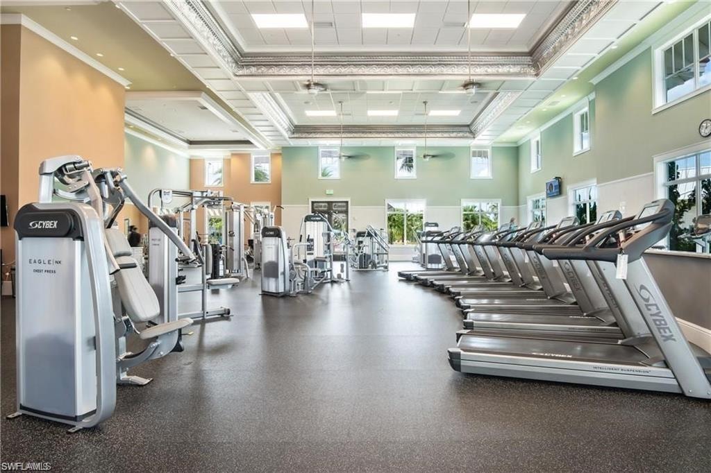 Spacious fitness center featuring a rubberized floor and a variety of cardio and strength training equipment