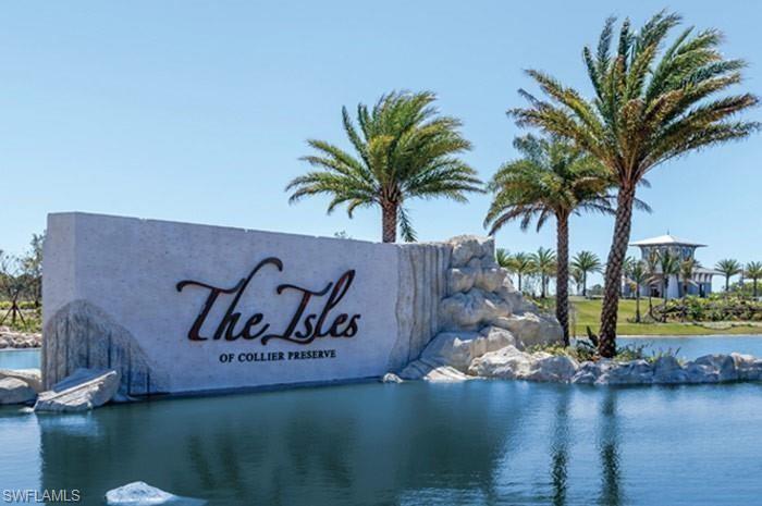 Community entrance sign featuring a prominent water feature with decorative rockwork