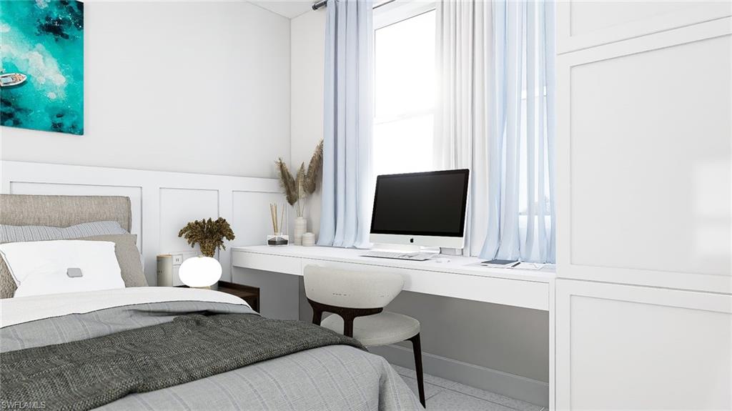 Bedroom with a decorative wall and a desk