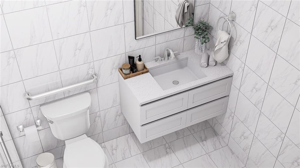 Bathroom with vanity and tile walls