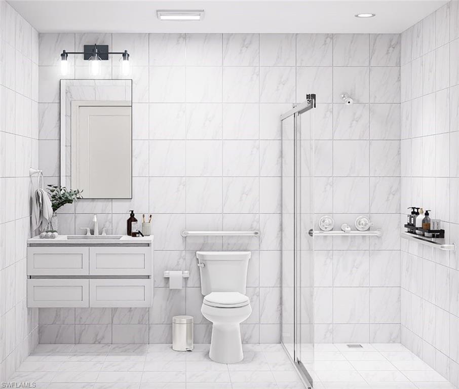 Full bathroom featuring a stall shower, vanity, and tile walls