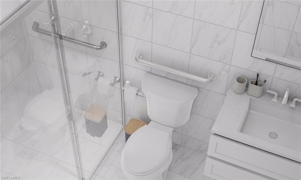 Full bathroom with vanity, tile walls, and a shower stall