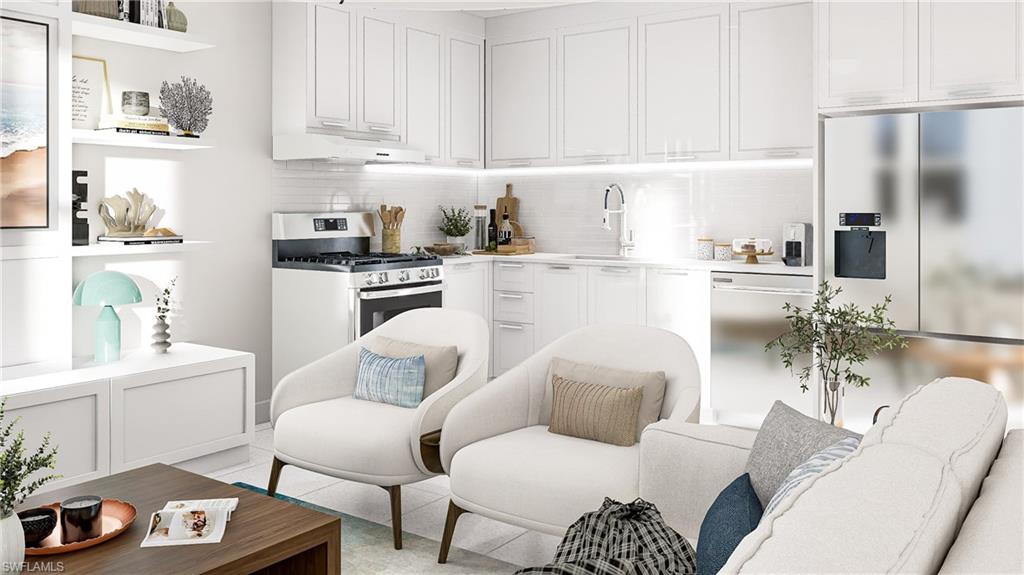 Kitchen featuring white cabinets, stainless steel appliances, decorative backsplash, light countertops, and under cabinet range hood