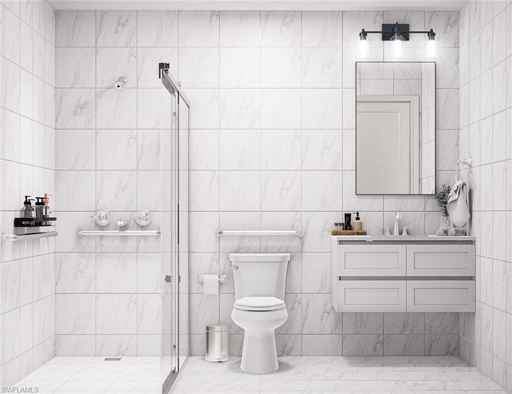 Full bathroom featuring a stall shower, vanity, and tile walls