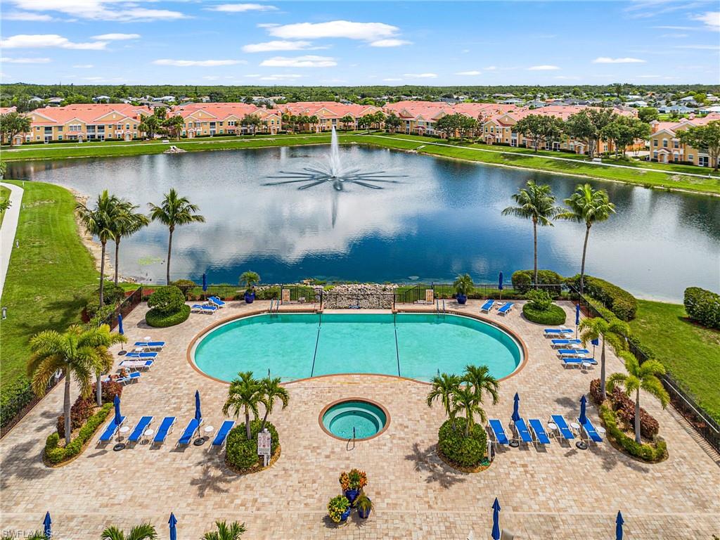 Community pool featuring a water view, a residential view, and a community hot tub