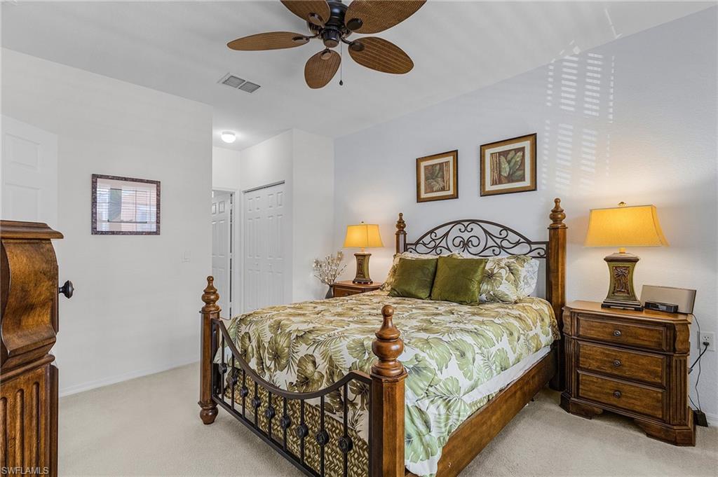 Carpeted bedroom with a closet and a ceiling fan