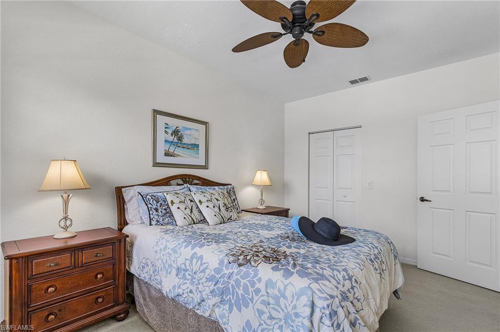 Bedroom with carpet floors, ceiling fan, and a closet