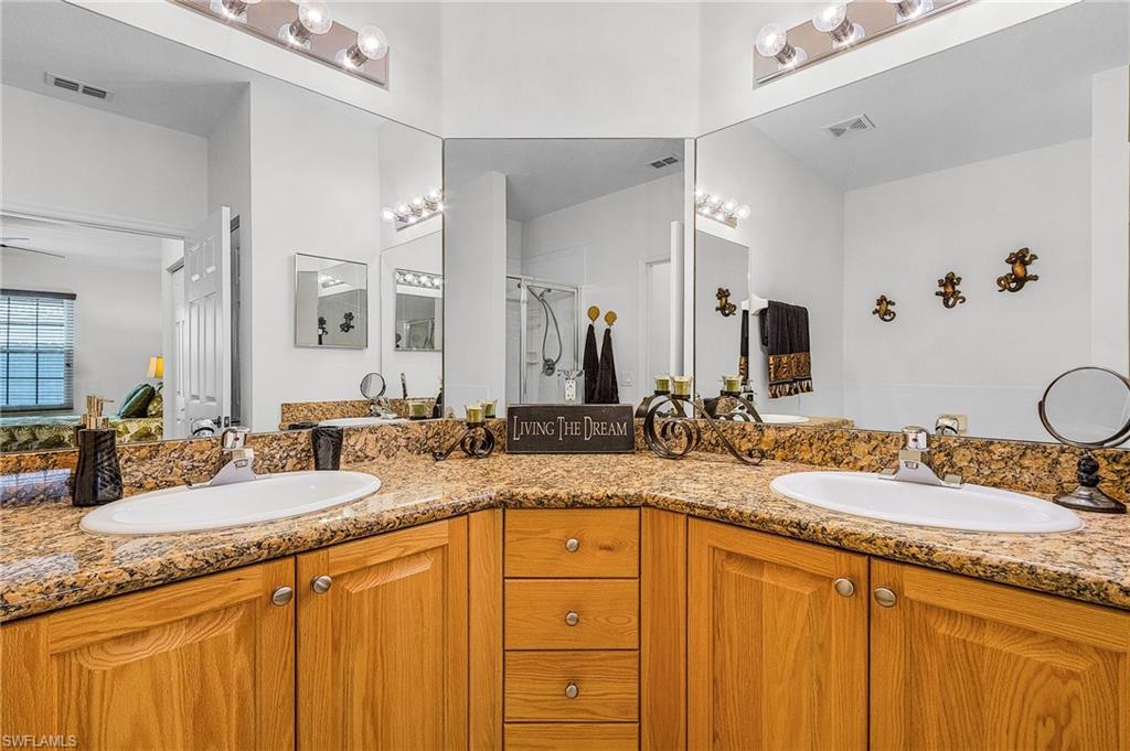 Bathroom with double vanity and a shower stall