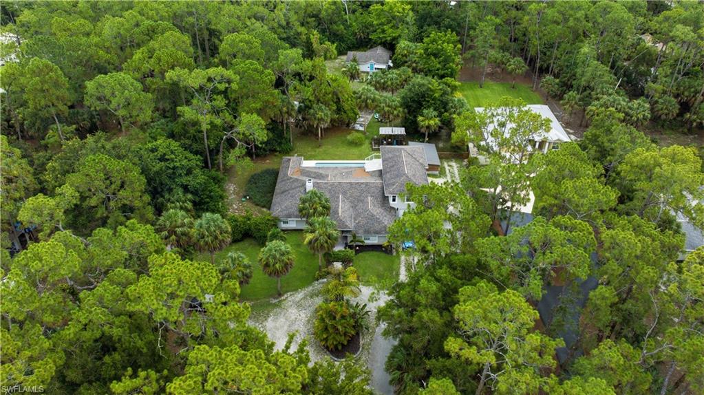 Aerial perspective highlighting a large residential property surrounded by mature trees