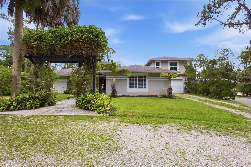 Stucco exterior with white-framed windows and an attached garage