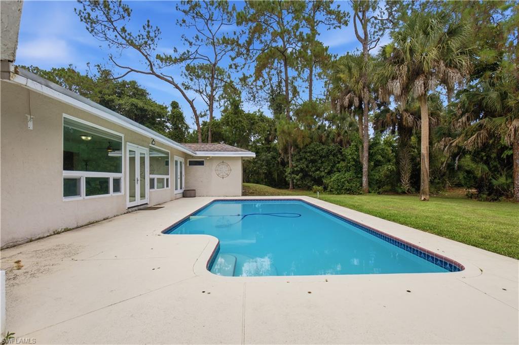 Rectangular swimming pool with integrated steps and a surrounding concrete patio
