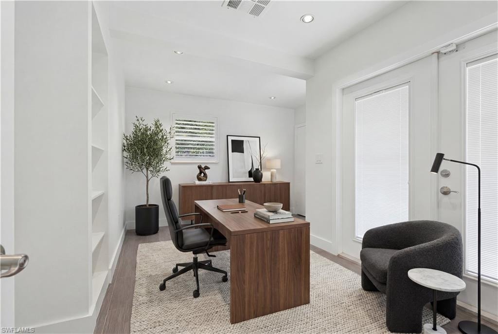 Bright interior space featuring recessed lighting, wood-finish flooring, and built-in shelving
