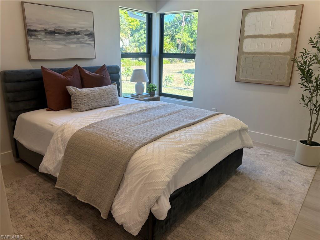 Bedroom featuring baseboards and wood finished floors
