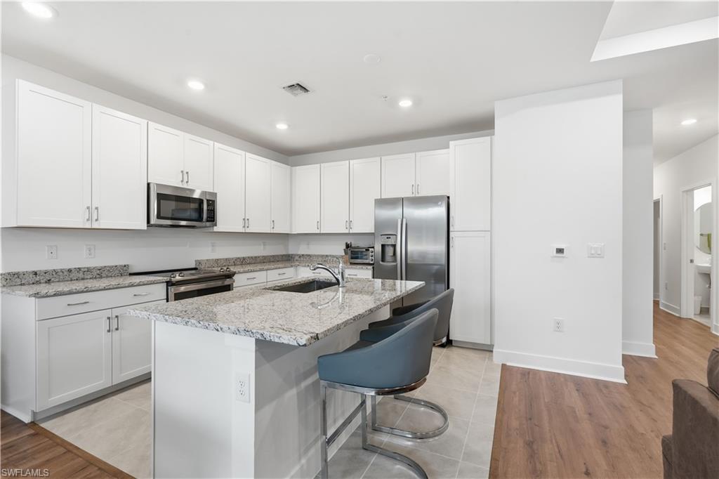 This kitchen has ample cabinetry, granite countertops, and stainless appliances.